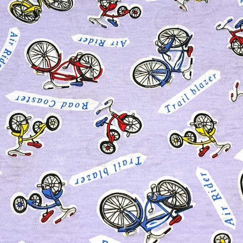 Cotton Jersey T-Shirt Knit, Bike Fabric with Bicycles and Tricycle on Lavendar Background. 2-way stretch. Sold by the 1/2 yard